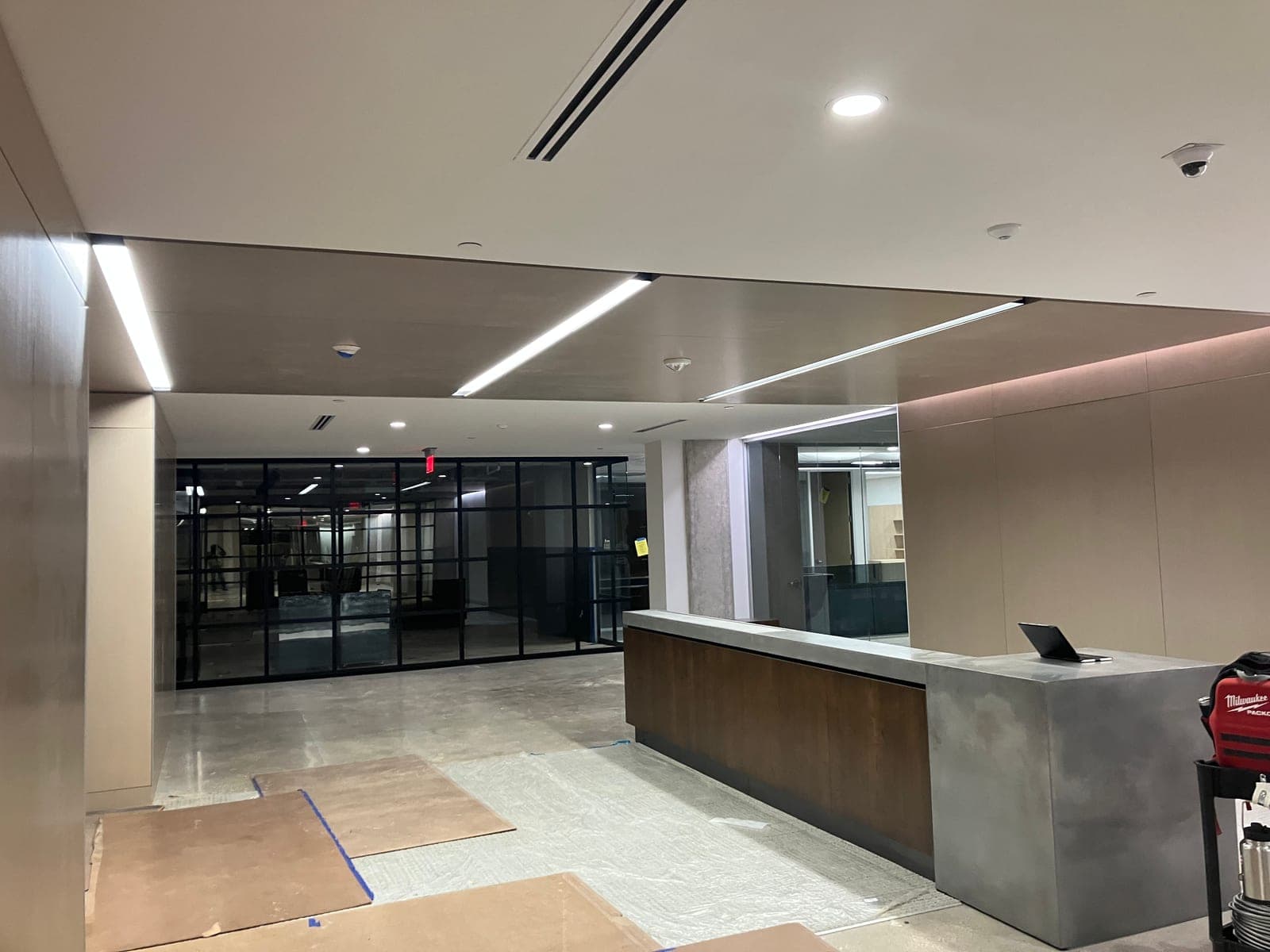 Modern commercial lobby with linear LED lighting and reception desk