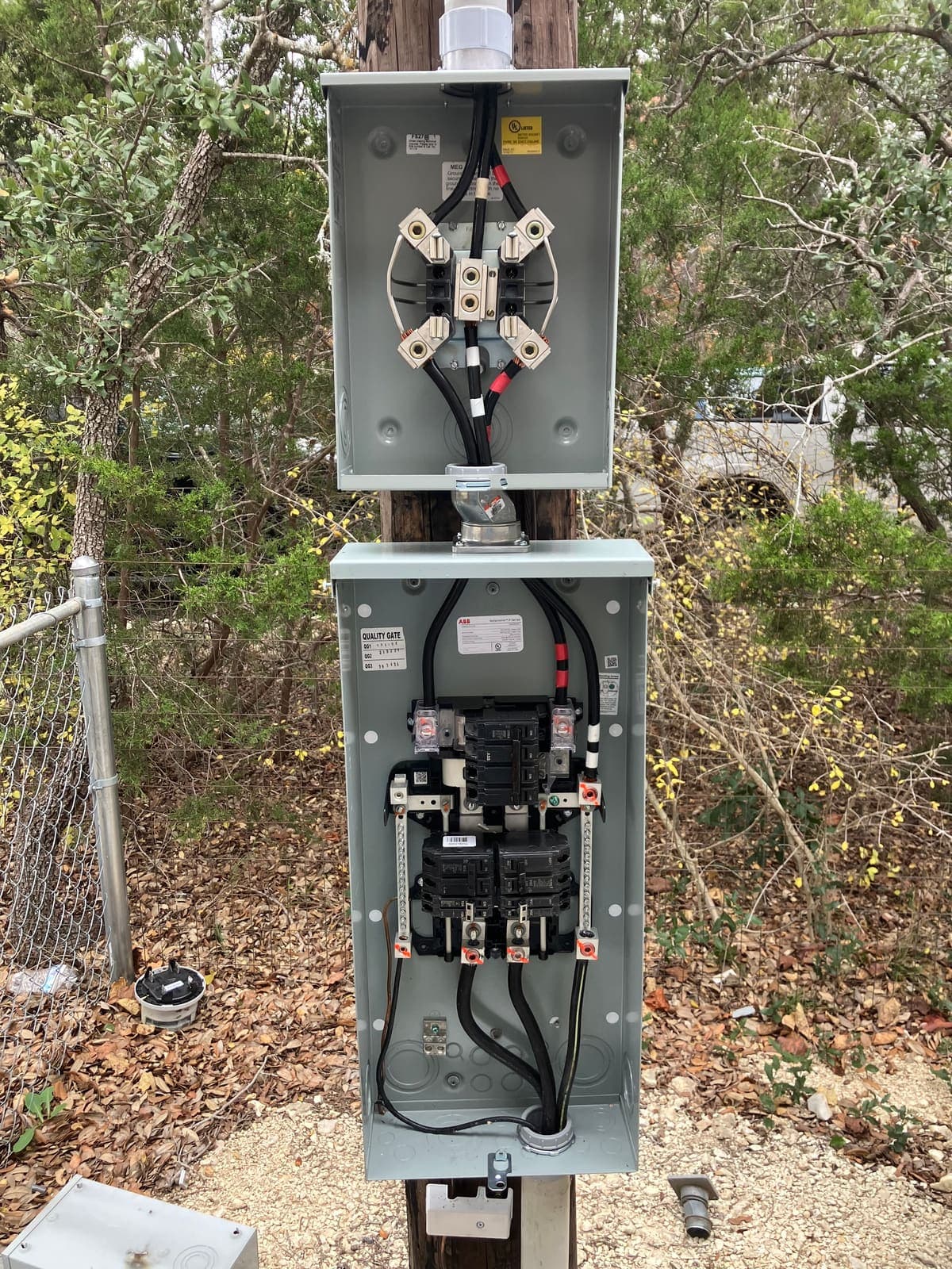 Newly installed residential meter base and main breaker panel on a service pole